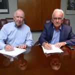 Signing the agreement is (left) APC Chairman Donald J Keehan, and (right) Peter Huni, President of HUNI + CO